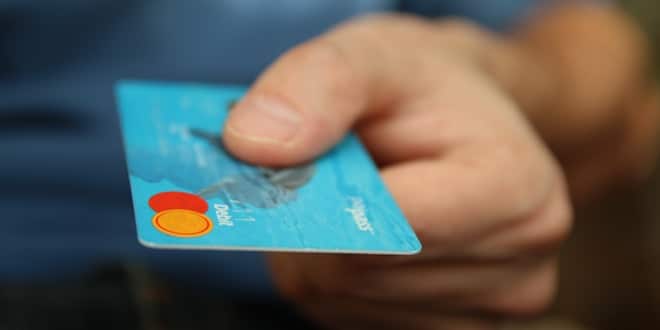 man offering credit card